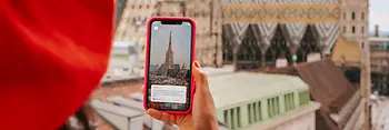 Woman with smartphone, and St. Stephen's Cathedral in the background