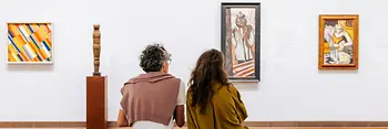 Museum visit Albertina, two people sit on a bench and look at art