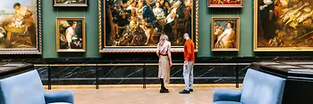 Kunsthistorisches Museum in Vienna. A man and a woman look at paintings from the Baroque period.