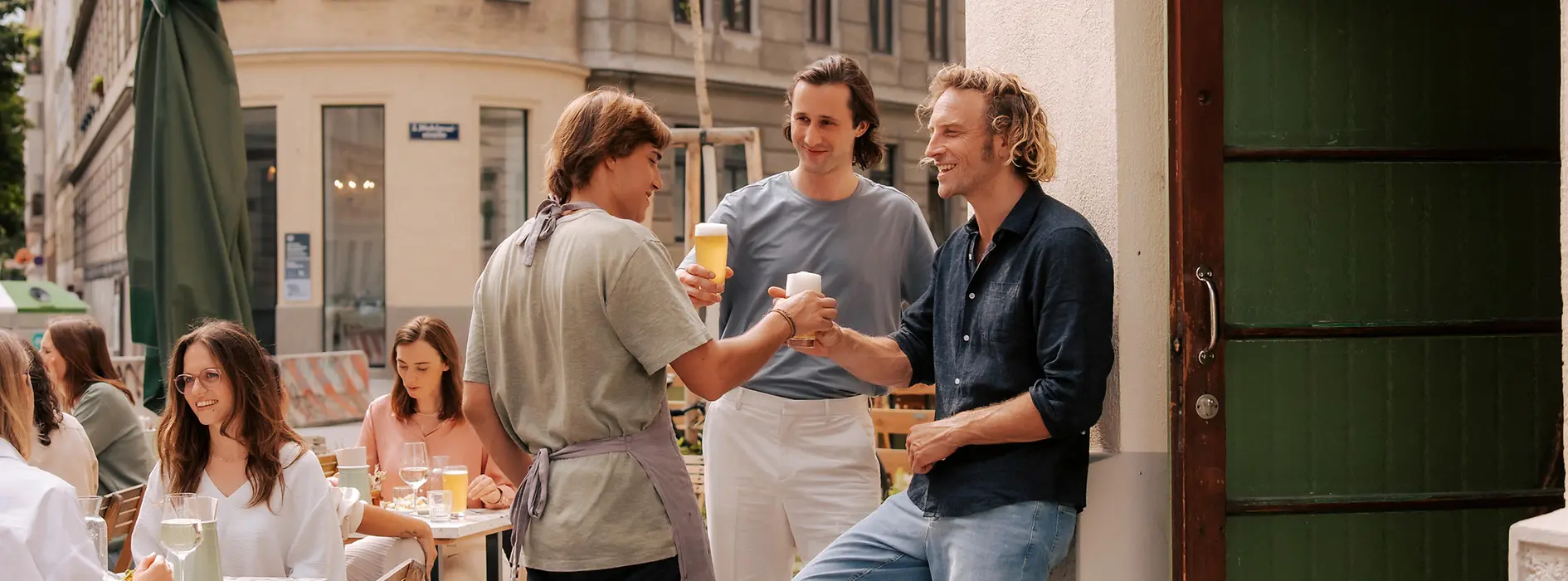 People in front of the entrance to a bar