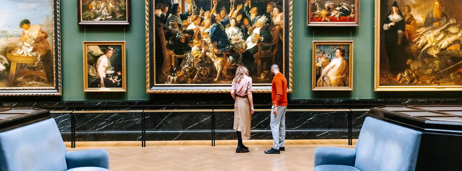 Kunsthistorisches Museum in Vienna. A man and a woman look at paintings from the Baroque period.