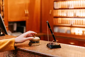 Person at reception presses bell