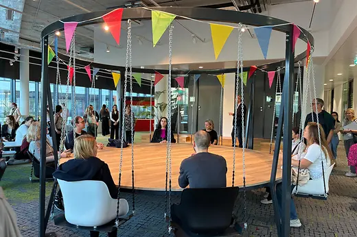 Personen sitzen rund um einen Konferenztisch